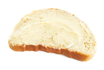 Slice of bread with fresh butter on white background