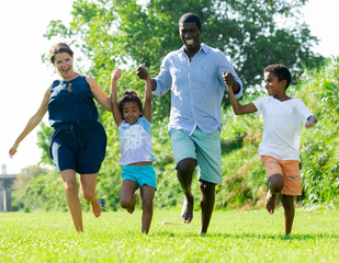 Family running in summer park