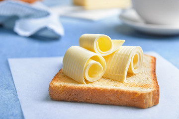 Slice of bread with butter on table