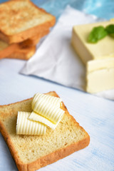 Slice of bread with butter on table