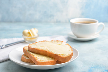 Plate with slices of bread and butter on color background