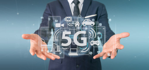 Businessman holding a 5G connection with data surrounding - 3d rendering