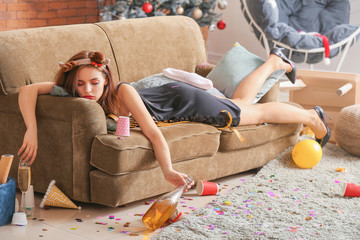 Young woman sleeping after New Year party at home