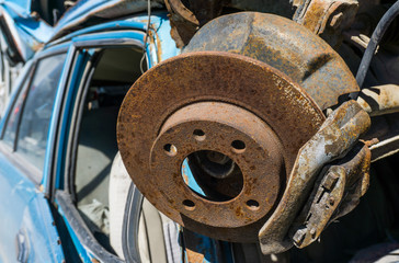 Old damaged cars on the junkyard waiting for recycling