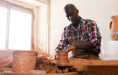 Man making ceramics on pottery wheel