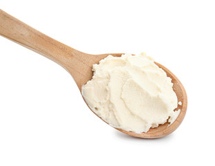 Spoon with tasty cream cheese on white background