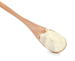 Spoon with tasty cream cheese on white background
