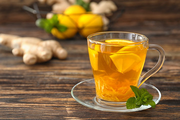 Cup of tasty ginger tea on table