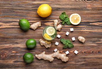 Composition with tasty ginger lemonade on wooden background