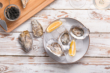 Composition with tasty oysters on wooden background
