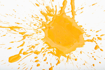 Orange paint spots on paper, colorfull artistic image on white background