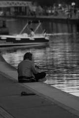 man sitting on pier