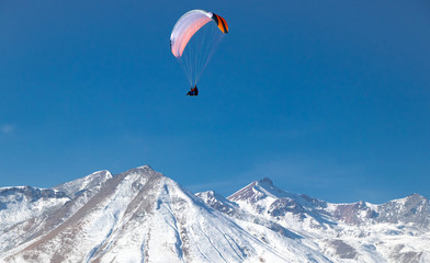 Fototapeta na wymiar Paragliding Above the Caucasus Mountains - Gudauri, Georgia (Winter)