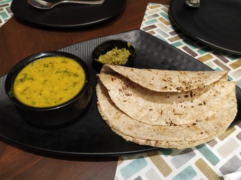 Traditional Maharastrian food- Pithal Bhakri served with dry curry. 