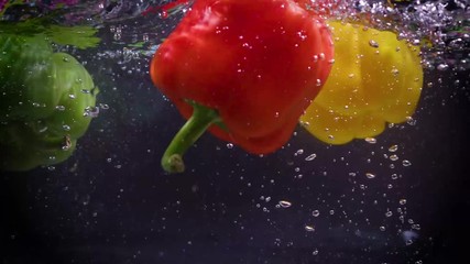 Raw and healthy green pepper elegantly falls into pot of fresh crystal clear water. - Powered by Adobe