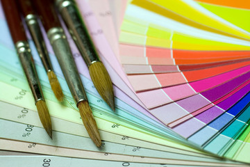 Fototapeta premium Brushes on a color print of pantone statistics offset scale