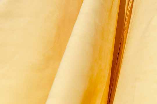 Pastel yellow fabric background