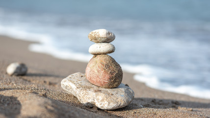 Balanced stones on the beach. Cairn. Appeasement, bright, beautiful background.