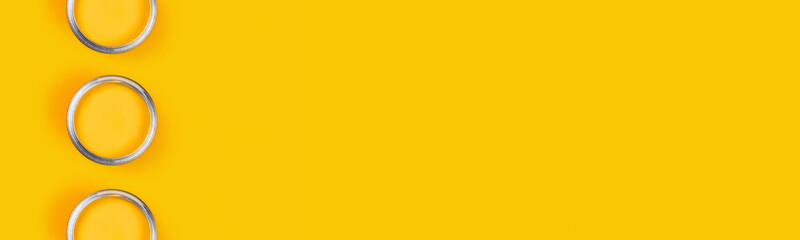 Renovation web-banner. Yellow backdrop with three paint cans in the centre of picture. Flat lay,...