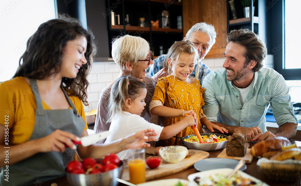 Wall mural Cheerful family spending good time together while cooking in kitchen