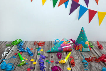 The concept of birthday. Festive accessories and paper decorations for a wooden background party. Free space.