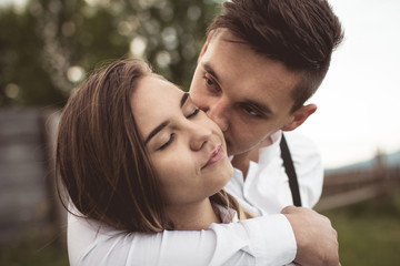 Fototapeta premium loving couple walking, having fun, hugging and kissing in the mountains