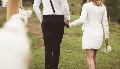 Obraz premium loving couple walking, having fun, hugging and kissing in the mountains