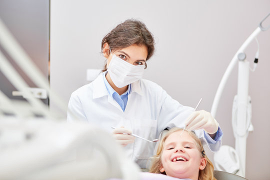 Dentist with surgical mask during treatment