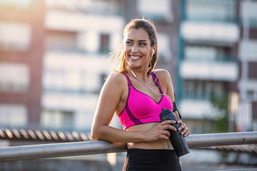 Fitness woman Relaxing after exercise with a whey protein bottle. Relaxing after training....
