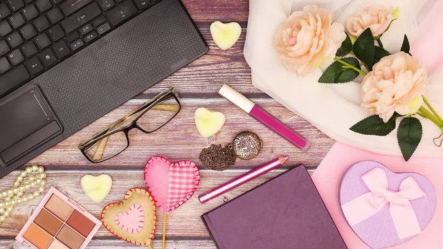 Romantic pink pastel feminine office table with moving stylish accessories and lap top - Stop motion 