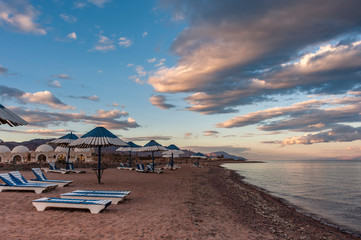 Sun loungers on sea shore