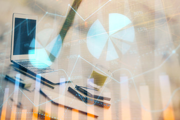 Forex graph hologram on table with computer background. Multi exposure. Concept of financial markets.
