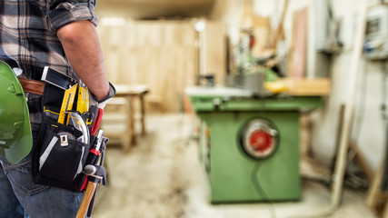 Close-up. Carpenter inside the carpentry workshop. Construction industry.