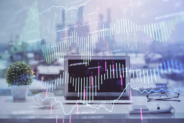 Forex Chart hologram on table with computer background. Multi exposure. Concept of financial markets.