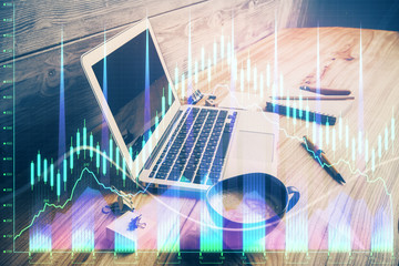 Double exposure of graph and financial info and work space with computer background. Concept of...