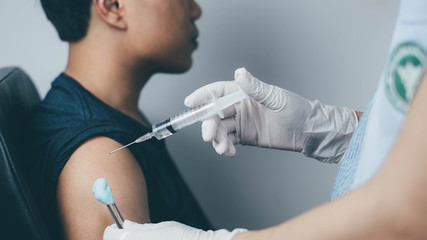 The doctor carried a syringe to treat and gave the patient a Sein measurement.Vaccination concept. Healthcare, hospital and medical diagnostics.