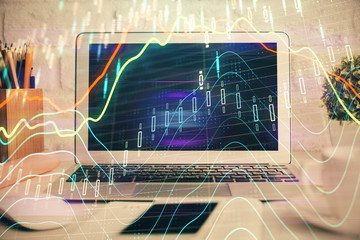 Stock market chart hologram drawn on personal computer background. Multi exposure. Concept of investment.