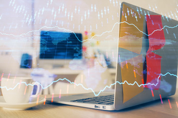 Financial chart drawing and table with computer on background. Double exposure. Concept of international markets.