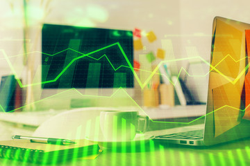 Financial market graph hologram and personal computer on background. Double exposure. Concept of forex.