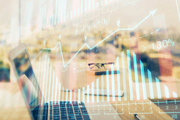 Stock market graph on background with desk and personal computer. Multi exposure. Concept of...