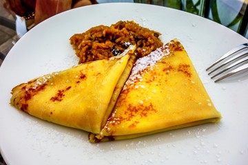 Sweet pancakes with stewed apples and raisins.