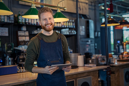 Smiling Waiter Ready To Take Order At Pub