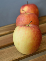 three apples lined up on the garden table