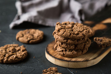 Fresh chocolate chip cookies on a dark background