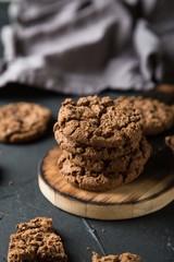 Fresh chocolate chip cookies on a dark background