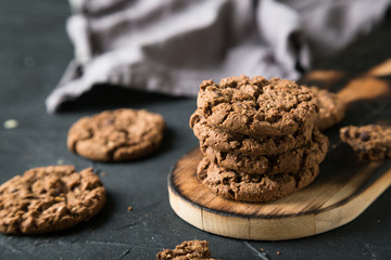 Fresh chocolate chip cookies on a dark background