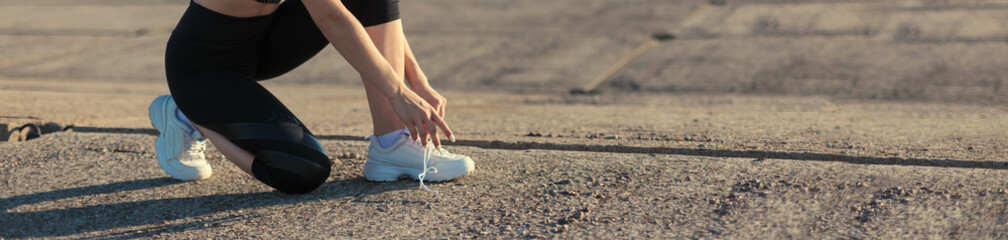A young slim athletic girl in sportswear with snakeskin prints performs a set of exercises. Fitness...