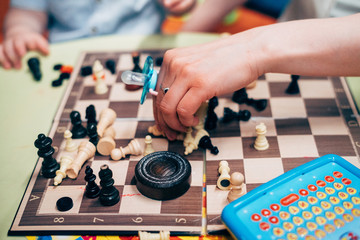 chessboard with scattered chess and toys on it