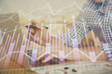 Multi exposure of forex graph with man working on computer on background. Concept of market analysis.