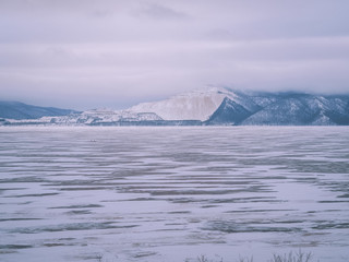 Icy landscape, blue mountains in the distance, icy desert, winter nature, ice on the river